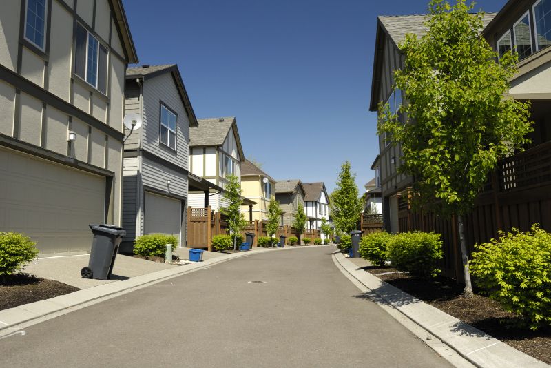 homes on a street with concrete driveway